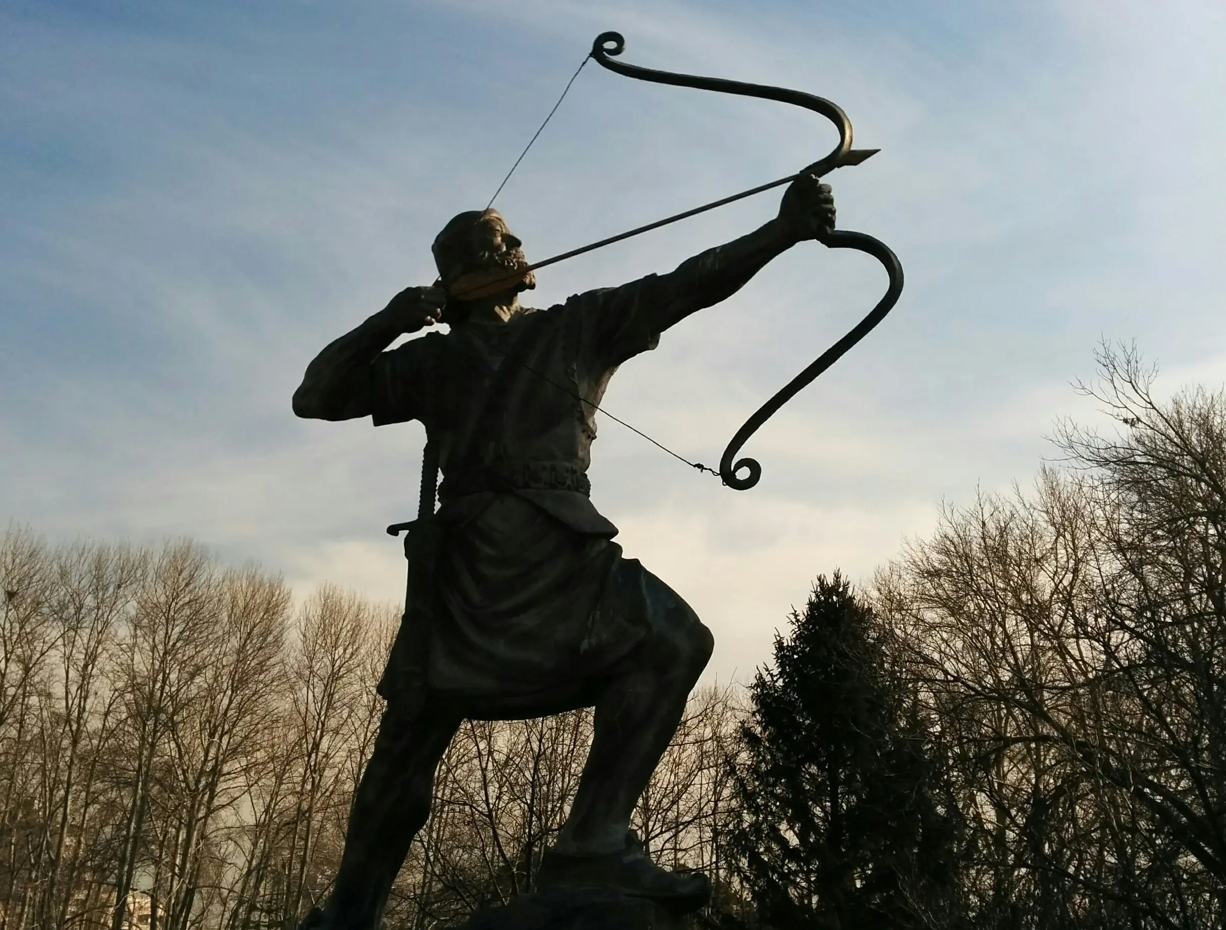 Man holding archer statue